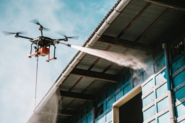 Drone spraying water on industrial building fire (ID#1)