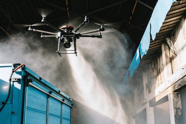 Drone spraying mist inside industrial building (ID#1)