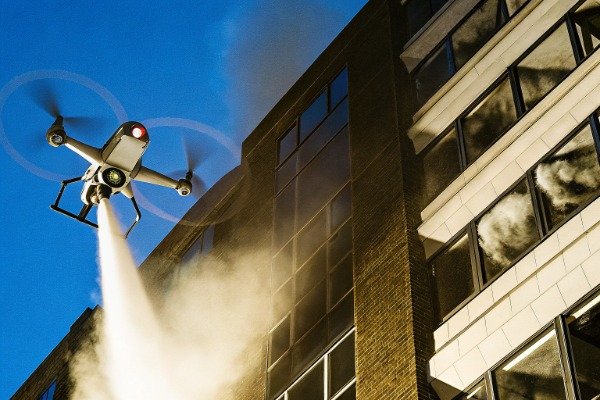 Drone spraying fire suppressant on building (ID#1)