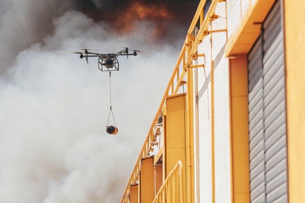Firefighting drone action Drone flying near heavy smoke with firefighting payload (ID#2)