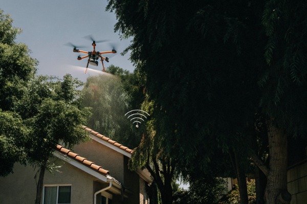 Firefighting drone action Drone spraying water over trees and house (ID#4)