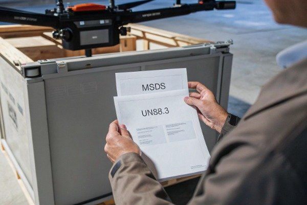 Professional reviewing safety documents for drone battery (ID#5)