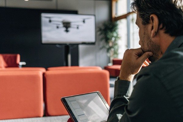 Drone procurement manager in modern office setting (ID#1)