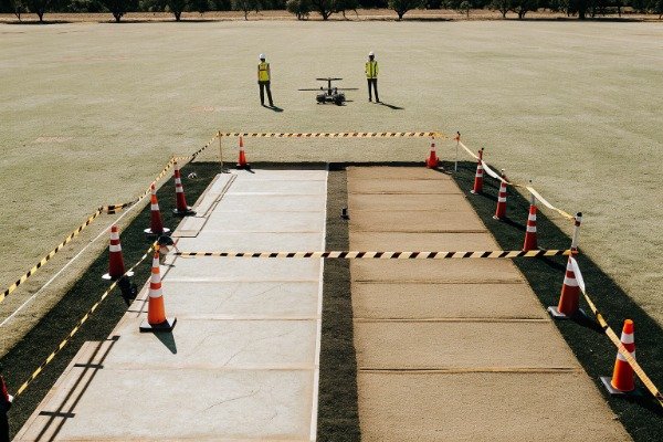 Safety field setup Safety personnel near drone in open field (ID#2)