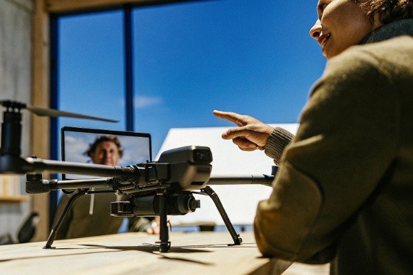 Drone sales pitch Sales representative presenting drone in modern office (ID#2)