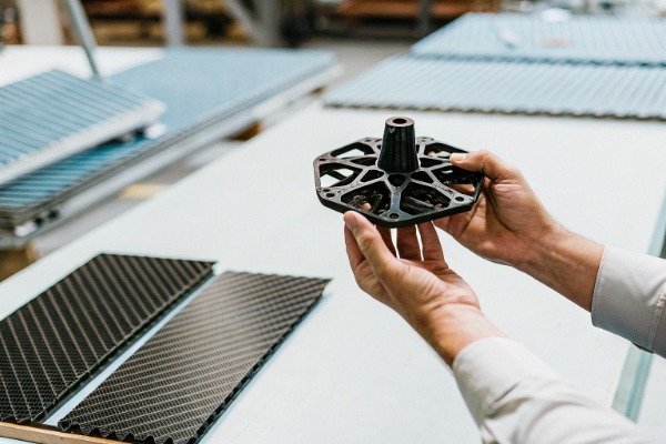 Close-up of hands holding drone part in factory (ID#2)