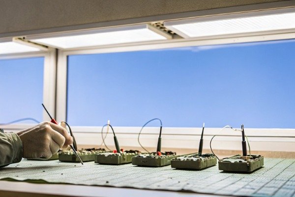 Technician testing drone ESCs with tools (ID#3)