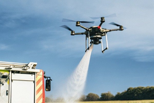 Drone water spray Drone spraying water near fire truck (ID#4)