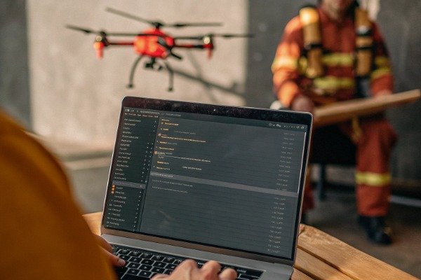 Firmware code development Drone firmware code development on laptop with drone nearby (ID#5)