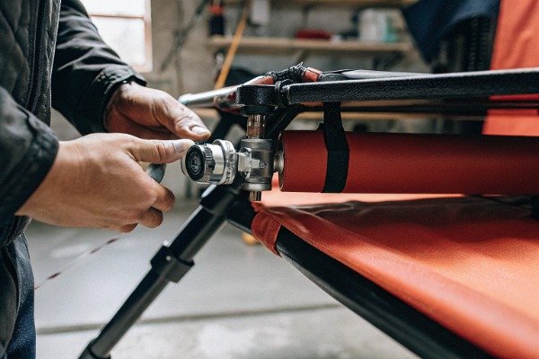 Technician attaching custom payload to drone in workshop (ID#5)
