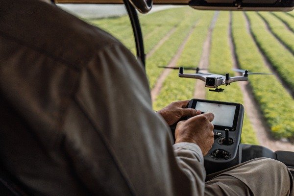 Controlling drone from vehicle Person controlling a drone from inside a vehicle over a field (ID#4)