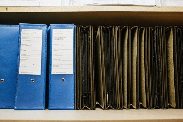 Office binders and files Row of blue binders and expanding files on a shelf (ID#4)