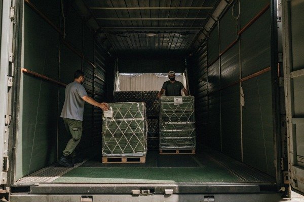 Logistics and shipping Workers loading large crates onto a truck for transport (ID#5)