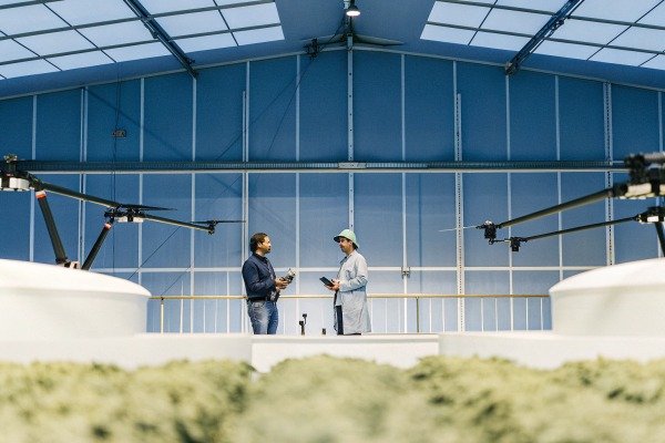 Engineers with drones Two engineers discussing drone operations inside a large facility (ID#5)