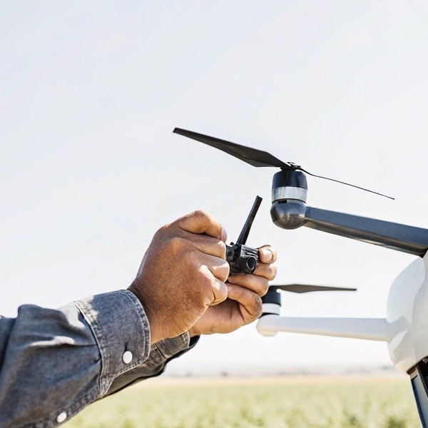 Hands adjusting drone propeller close-up (ID#1)