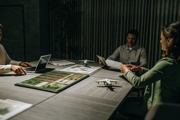 Team discussing drone plans at conference table (ID#5)