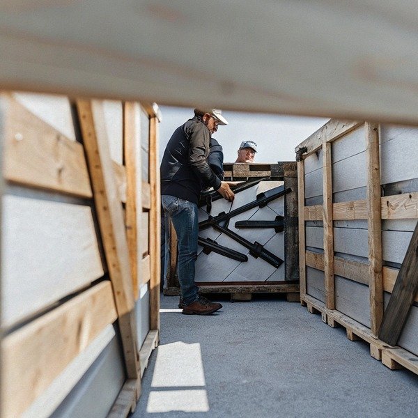 Workers handling large crates outdoors (ID#1)