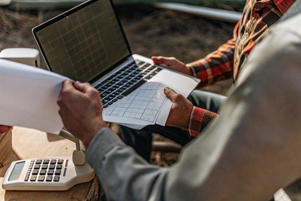 People reviewing agricultural data on laptop (ID#3)
