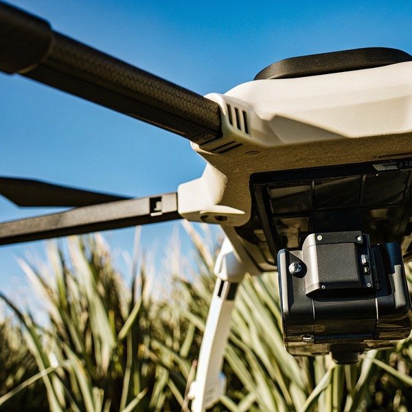 Close-up of drone arm and camera in field (ID#1)