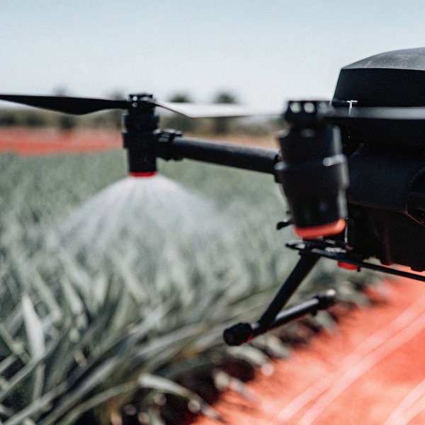Drone spraying crops in field close-up (ID#1)