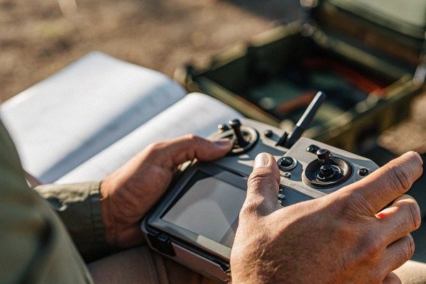 Drone control Hands holding drone remote controller outdoors (ID#5)