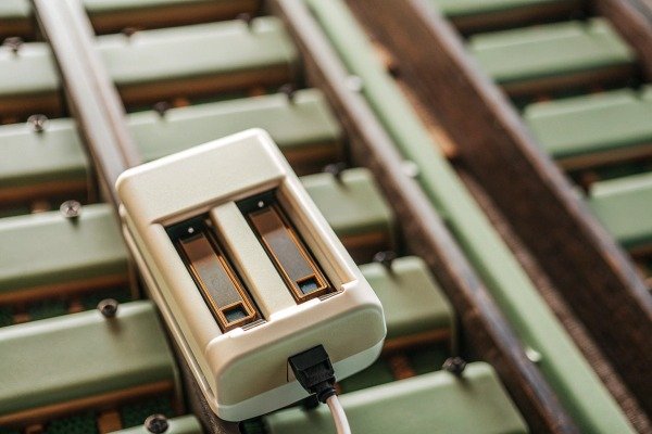 Battery charger on green equipment close-up (ID#2)