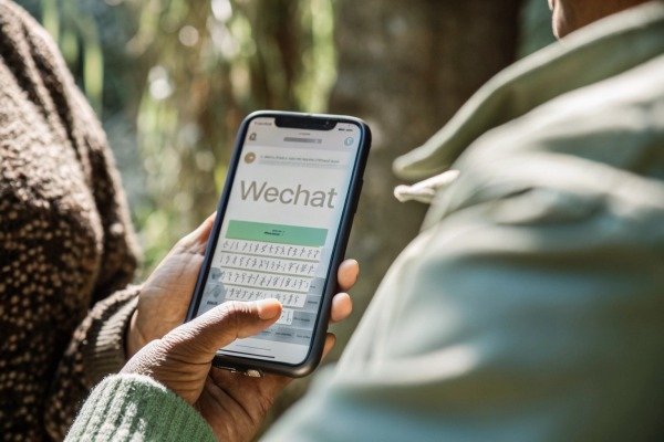 Person using WeChat app on smartphone (ID#3)
