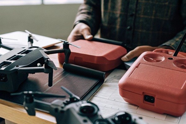 Hands handling drone and remote controllers (ID#5)