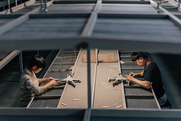 Workers assembling drones in factory (ID#5)