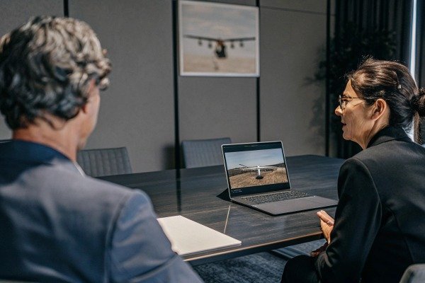 Two people discussing drone on laptop screen (ID#5)