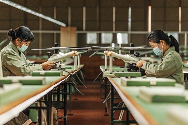 Workers assembling drones in factory with masks (ID#2)