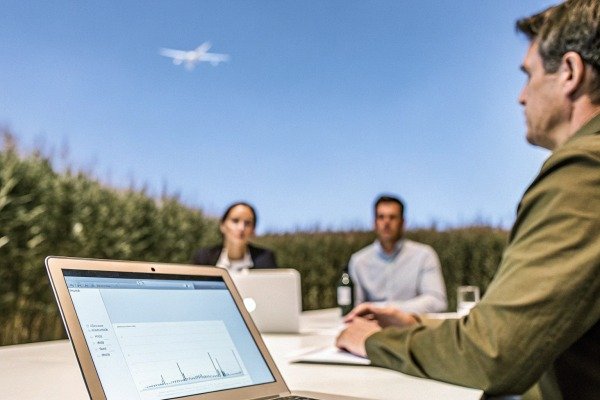 Business meeting with laptop and drone flying (ID#5)