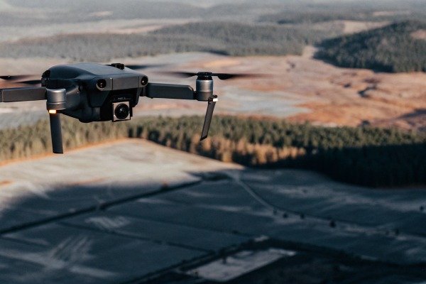 Drone flying over forest and fields aerial view (ID#4)