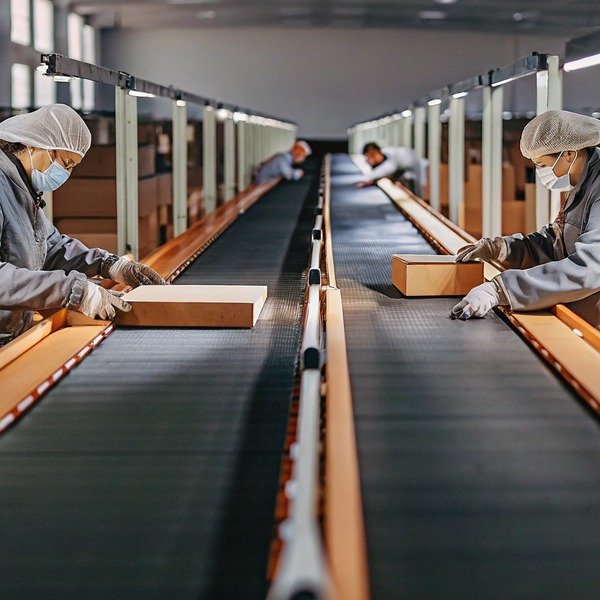 Workers inspecting packages on conveyor belt (ID#1)