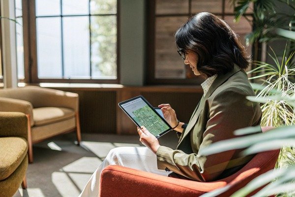 Woman using tablet indoors with sunlight (ID#2)