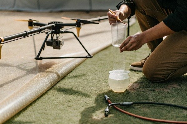 Person preparing drone with liquid sample (ID#3)