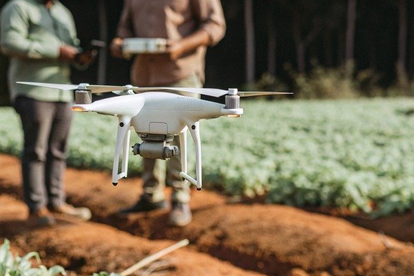 White drone flying over farmland (ID#4)