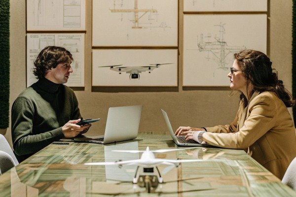 Two people discussing drone design in office (ID#5)