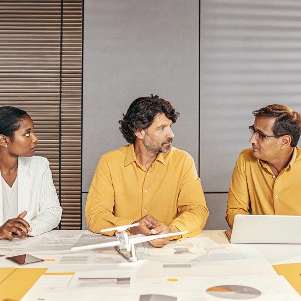 Business meeting with drone model on table (ID#1)