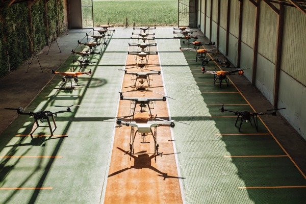 Multiple drones lined up inside warehouse (ID#4)