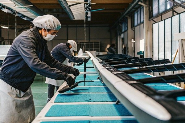 Workers assembling drone parts in factory (ID#3)