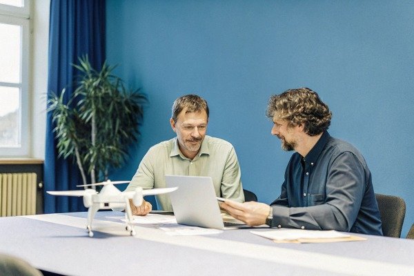 Two men discussing drone technology (ID#5)