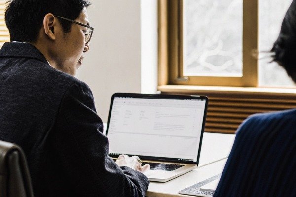 Man working on laptop indoors (ID#2)