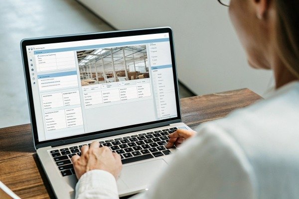 Person using agricultural software on laptop (ID#2)