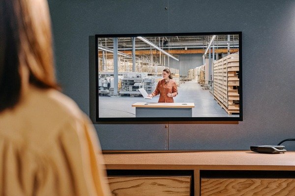 Woman watching industrial video on TV screen (ID#3)