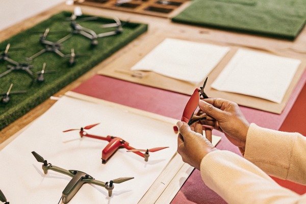 Hands assembling drone propellers on table (ID#4)
