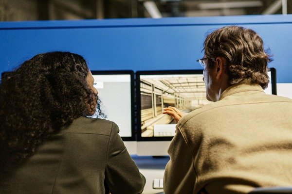 Collaborative work session Two people working on computer screens (ID#5)