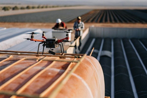 Drone on rooftop with workers in background (ID#2)