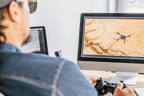 Man controlling drone with computer screen view (ID#4)