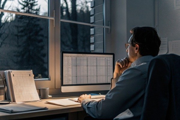 Man analyzing data on computer at night (ID#5)